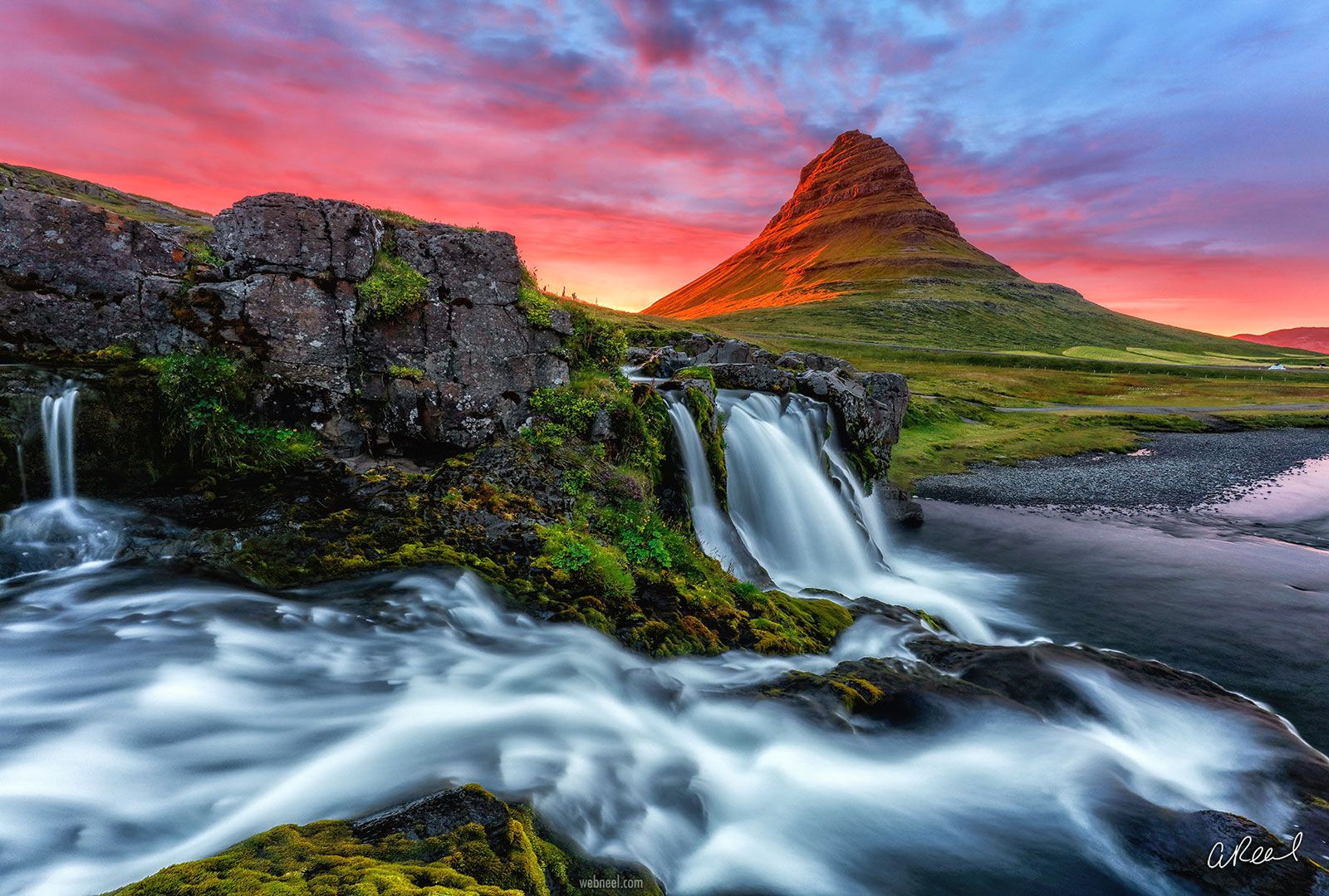 Beautiful flowing waterfall under a colorful sunset